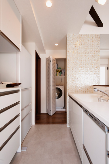 キッチンのもう一方は、トビラ付きの洗濯機置き場へとつながる