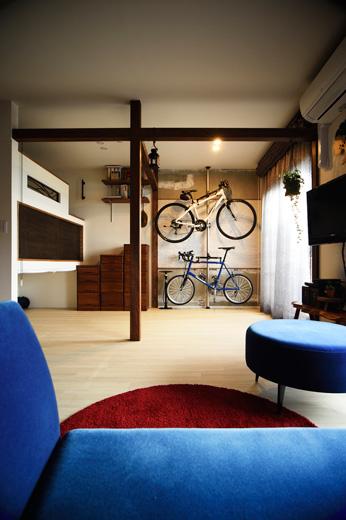 元和室はスポーツ好きなIさんご一家のトレーニングルームとしても活用。壁には自転車のポールを取り付け、飾りながら収納できるようにした。自転車がかかっている壁は、既存のクロスをはがして躯体をむき出しにし、ざっくりとした印象に。中央部分のみ白いタイルを貼った