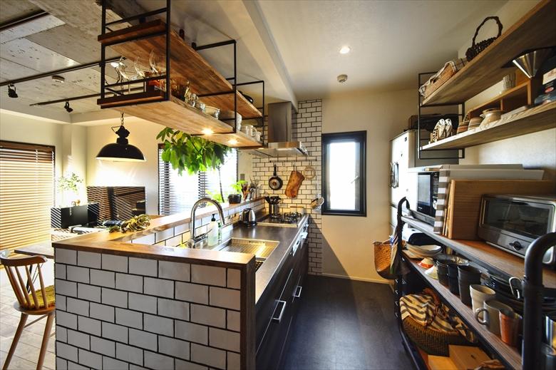 キッチンにはSさんお気に入りのタイルを使ったカウンターを造作。吊り戸棚はSさんが購入したアイアンに合わせ、棚板を取り付けたオリジナル。