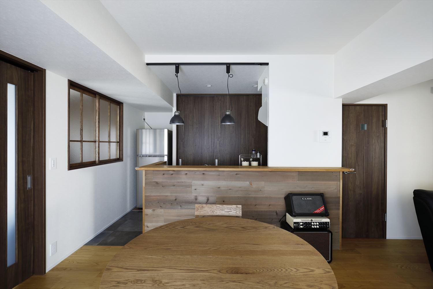 キッチンは向きを変えて対面式に。キッチン背面には大容量の収納を設けた。キッチンカウンターには古材を貼って、カフェ風に。