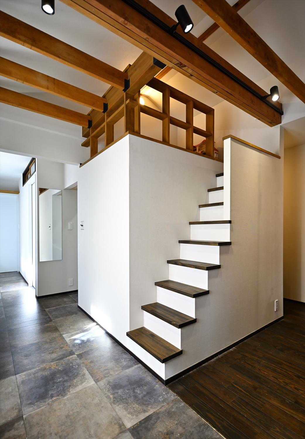 小屋裏を活用したキッズコーナー。散らかりがちなおもちゃの収納場所としても活躍している。濃い色で塗装した現しの根太で沖縄の古民家のような雰囲気に。