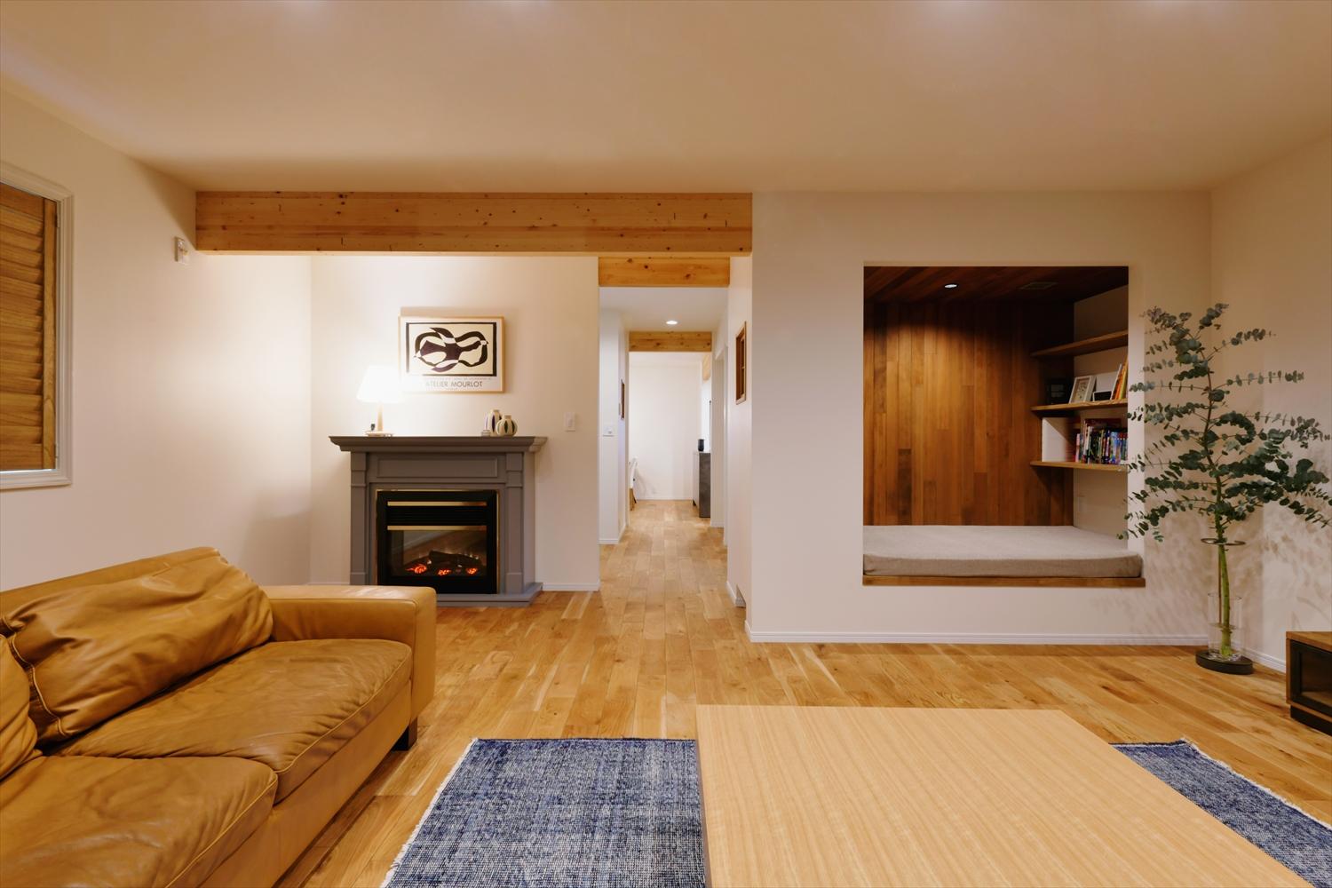 リビングの床はオークの無垢フローリングに張り替え。節の量やバランスを重視しながら丁寧に施工。梁やウッドブラインドなどの木目と、壁・天井の白を基調としたナチュラルテイストの空間に、グレーに塗装したマントルピースが差し色となり、上質感と素材感のあるインテリアに。