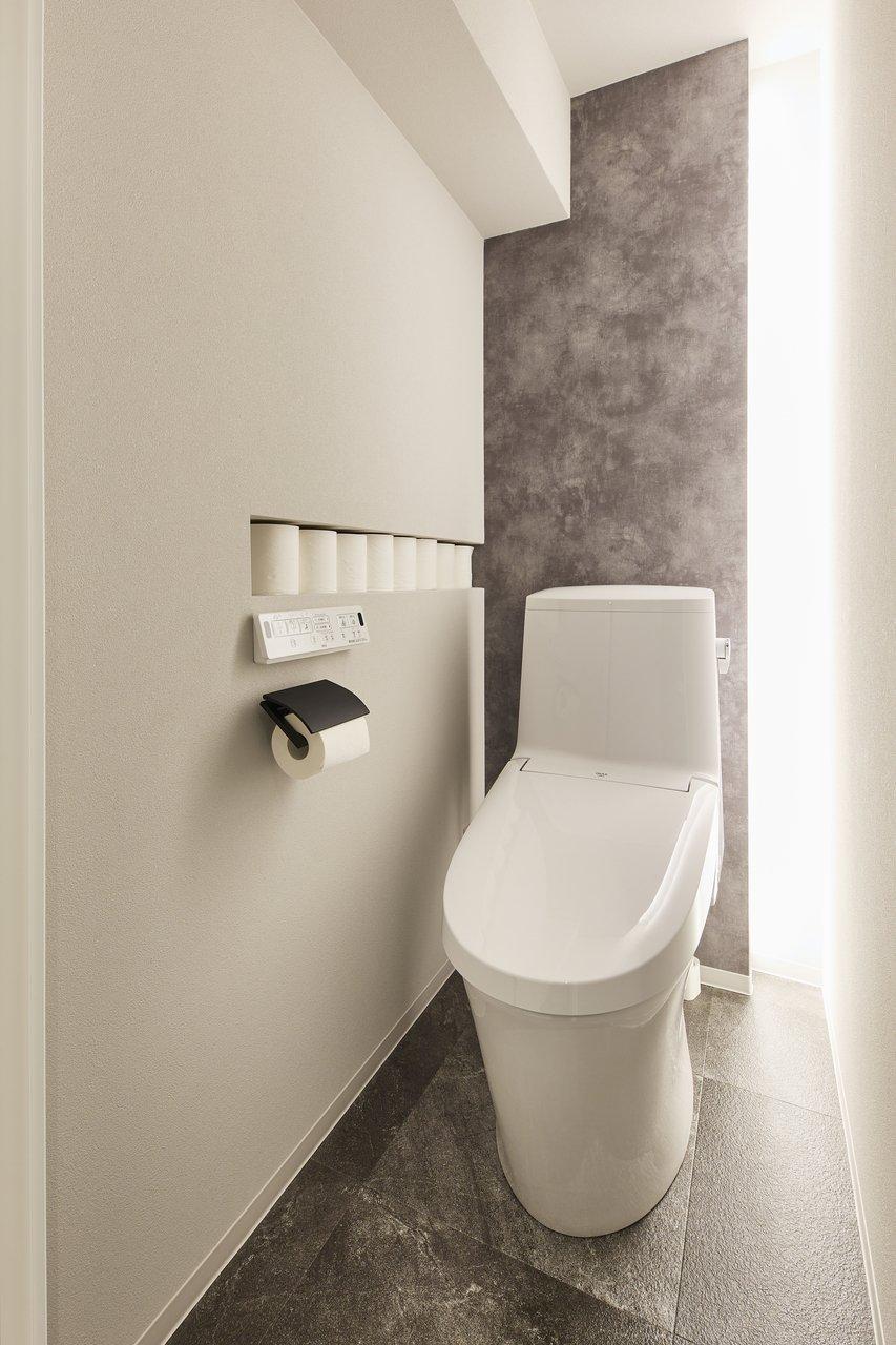 トイレットペーパーがぴったり収まるニッチと、間接照明がポイント。