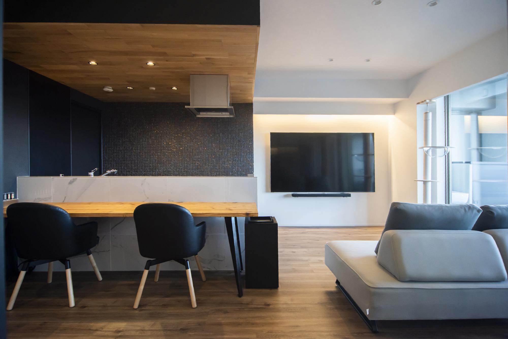 キッチン前面の腰壁には白い磁器質タイルを、壁面には黒い磁器質タイルを使用し、色のメリハリをつけています。