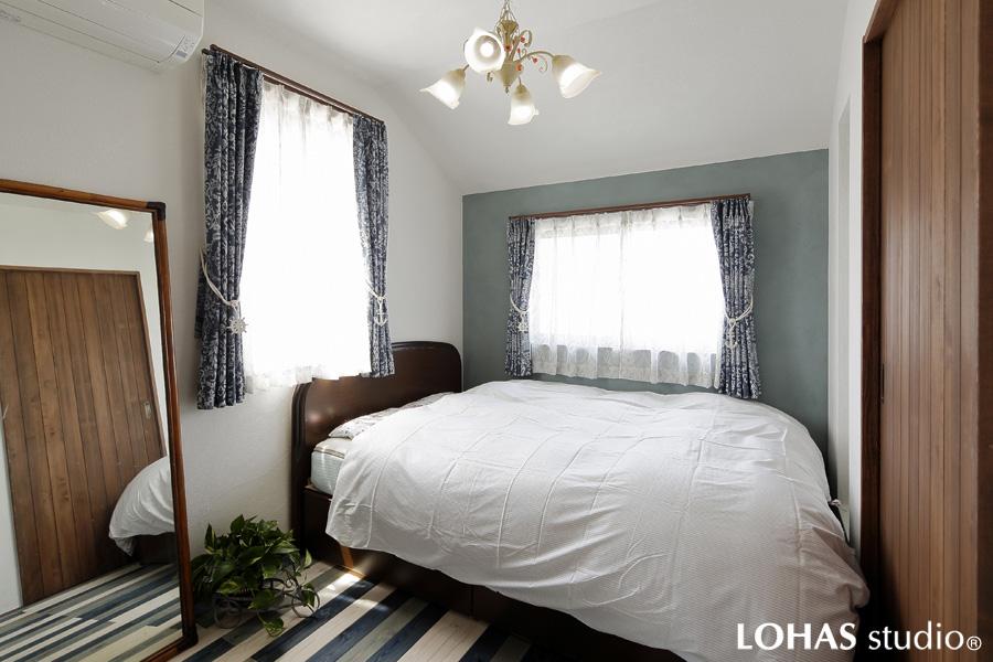 オリジナル調色でアクセント壁を造作した主寝室です。ブルーを基調にフローリングは3色を塗り替えました。植物モチーフの照明・カーテンが馴染んで洗練された華やかさを演出しています。
