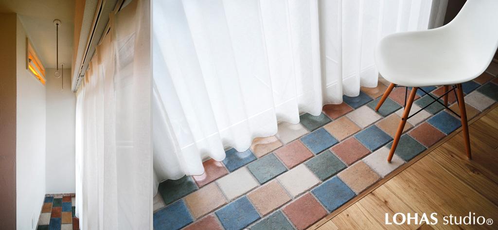 窓辺に造作したタイル5色が愉しいリビング・土間です。土汚れや水に強いので鉢植えや室内干しにも最適。隣室の壁には室内窓を設けて風が抜けるよう工夫しました。