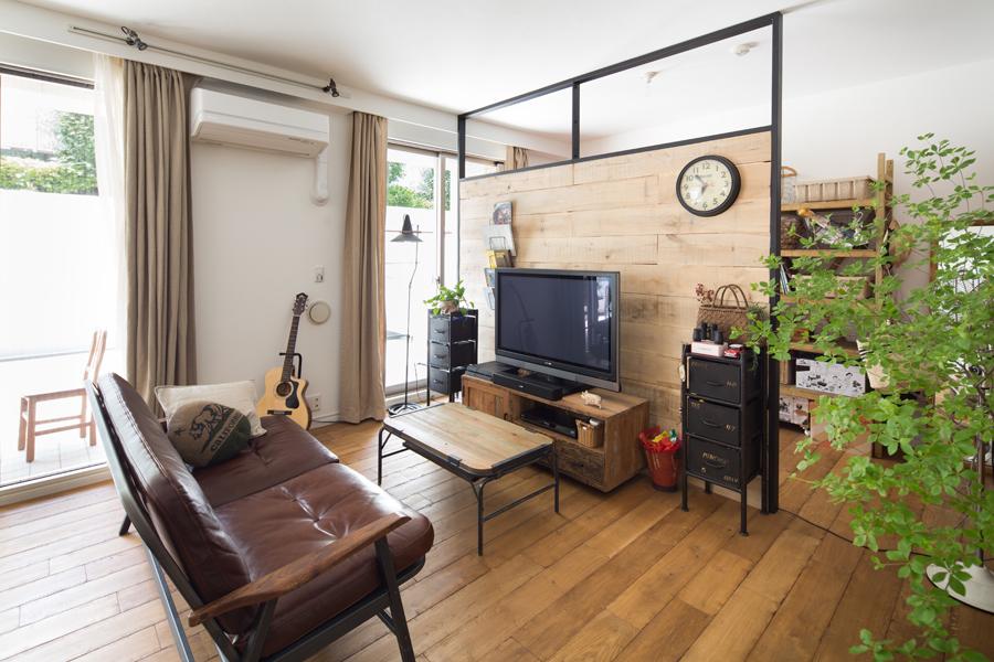 ヴィンテージな雰囲気のLDKです。古材とアイアンで造作した黒フレームのパーティションで背後のユーティリティ兼収納コーナーを隔てました。パーティションはS様の秀逸なアイデア作品。床はオーク材を粗く加工してマニッシュな仕上がりに。