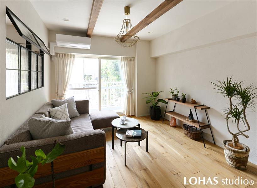 1日の大半を過ごすリビングは、飽きのこないようにシンプルなデザインにまとめました。天井に渡った2本の化粧梁が、珪藻土や無垢フローリングといったLOHAS studioが得意とする自然素材とベストマッチ！辛口アイテムのアイアン窓が空間を引き締めています。