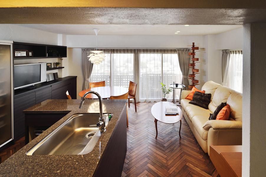 キッチンとのコミュニケーションを重視して家具レイアウトを工夫したLDです。中央の太い動線でスッキリとした見映え。ダイニングには「一目ぼれ」で購入した北欧照明を設置。