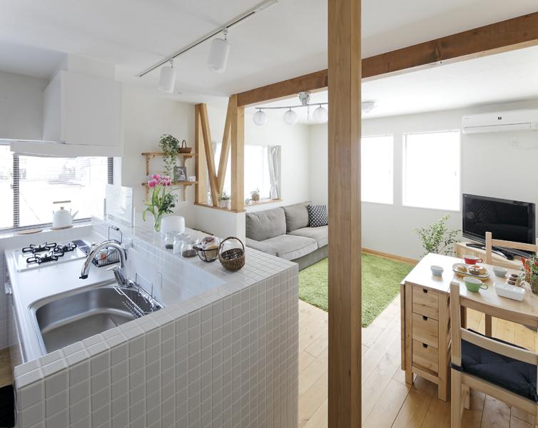 珪藻土や無垢床でナチュラルな子世帯LDKです。吹抜けに床を張り場所を確保しました。現しの柱は 構造上必要となる大事な柱。天井を走る化粧梁が印象的。視線の抜けを意識して４面の窓から光がたっぷり届くよう工夫を凝らしました。