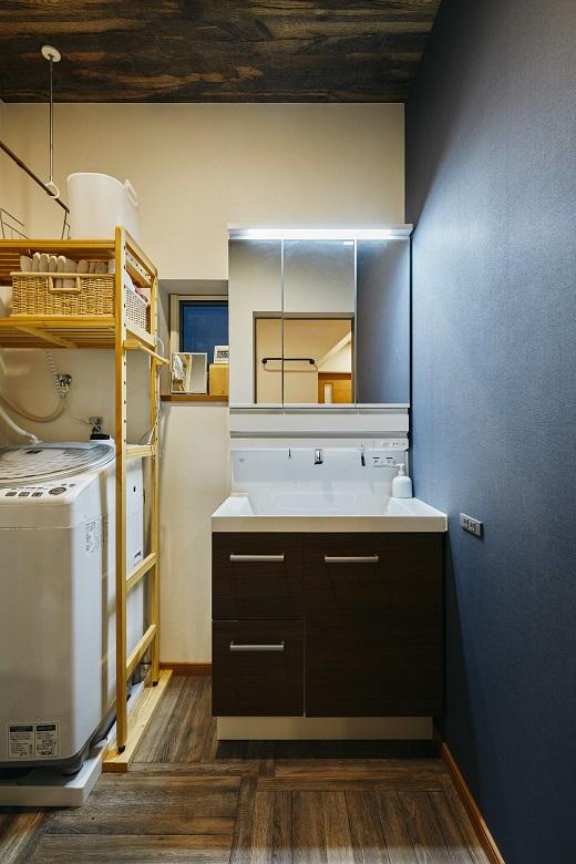 壁の色と統一した清潔感ある洗面台。壁にコンセントがついているのがポイント。