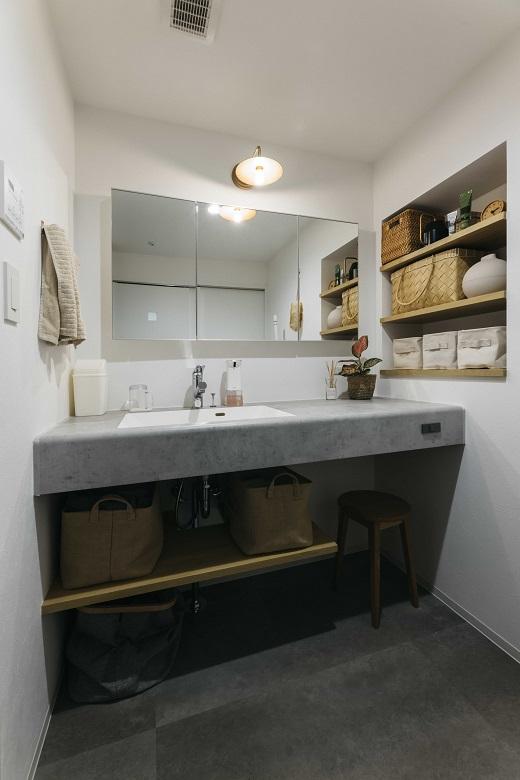 洗面台はAICAのメラミン天板を採用し、リビング同様モルタルと木が調和したデザインに。