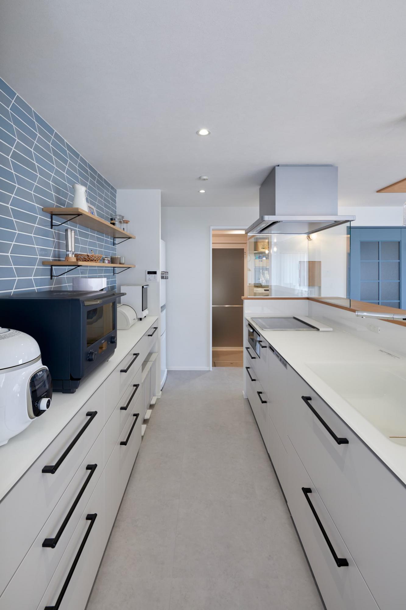 キッチン背面に貼ったのは、施主様が悩み選び抜いたブルーのタイル。模様や色味、質感も少し異なり、お洒落で可愛いらしい。