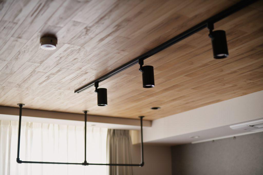 表情豊かな木目の天井材に黒のライティングレール＋スポットライトでスタイリッシュに仕上げました。