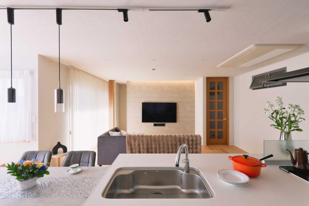 キッチンは対面にレイアウト変更。眺めがよくお料理も楽しくできます。テレビの背面はタイル調のクロスと間接照明を組み込んで高級感を演出。