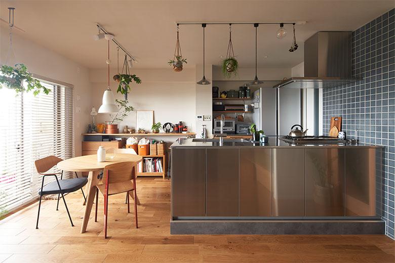 工業的なクールなデザインが好みで、キッチンはオールステンレスを希望。収納力も重視し、キッチン前面にもキャビネット収納をつけ、背面は上部をオープン棚にして家電を使いやすく並べられるようにした。対面式キッチンにしたことで床が一段高くなったが、ステージに立っているみたいで開放感は抜群だという。