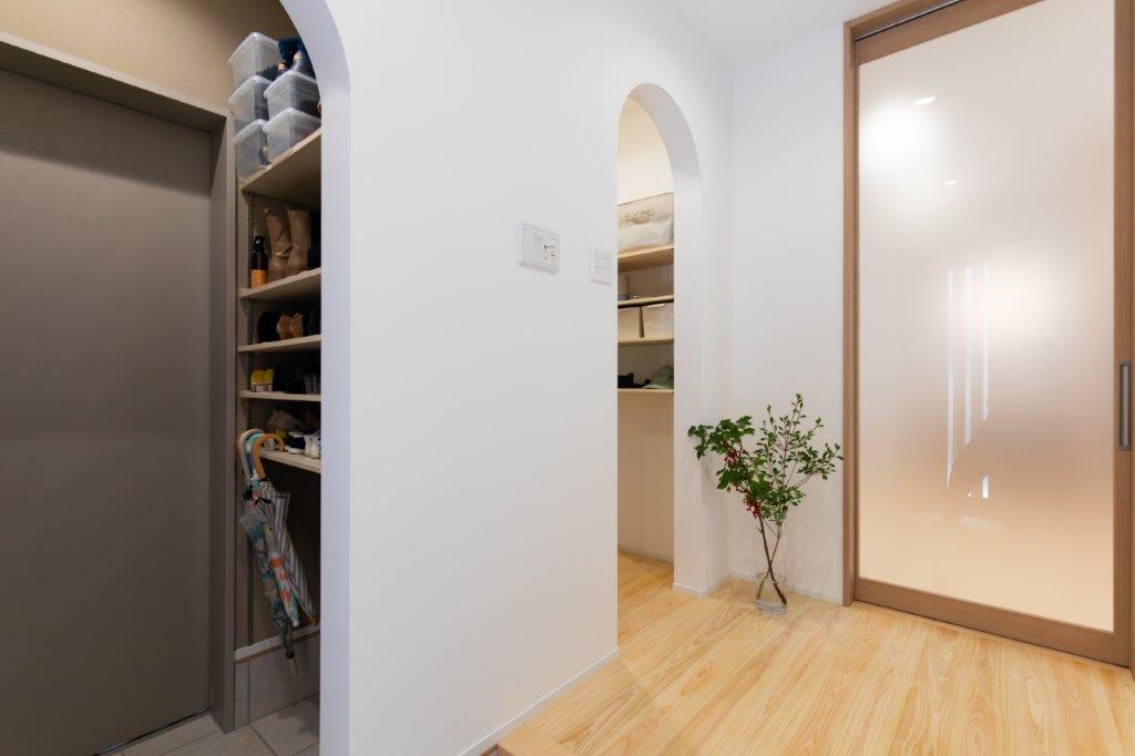 玄関から続く動線に、収納とやわらかなデザインをプラス。アーチの開口が空間にやさしい表情を与え、使いやすさと心地よさを両立した住まいを演出します。