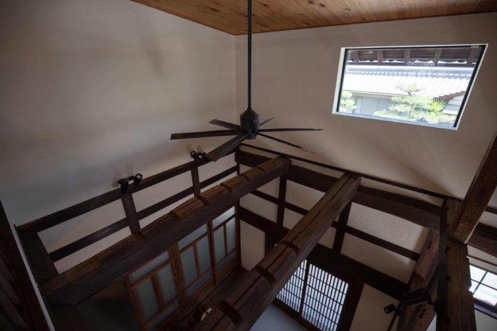 吹き抜けに広がる梁の力強さが印象的な空間。高窓から差し込む光が木の質感を引き立て、開放感と落ち着きを兼ね備えた心地よい住まいを演出します。